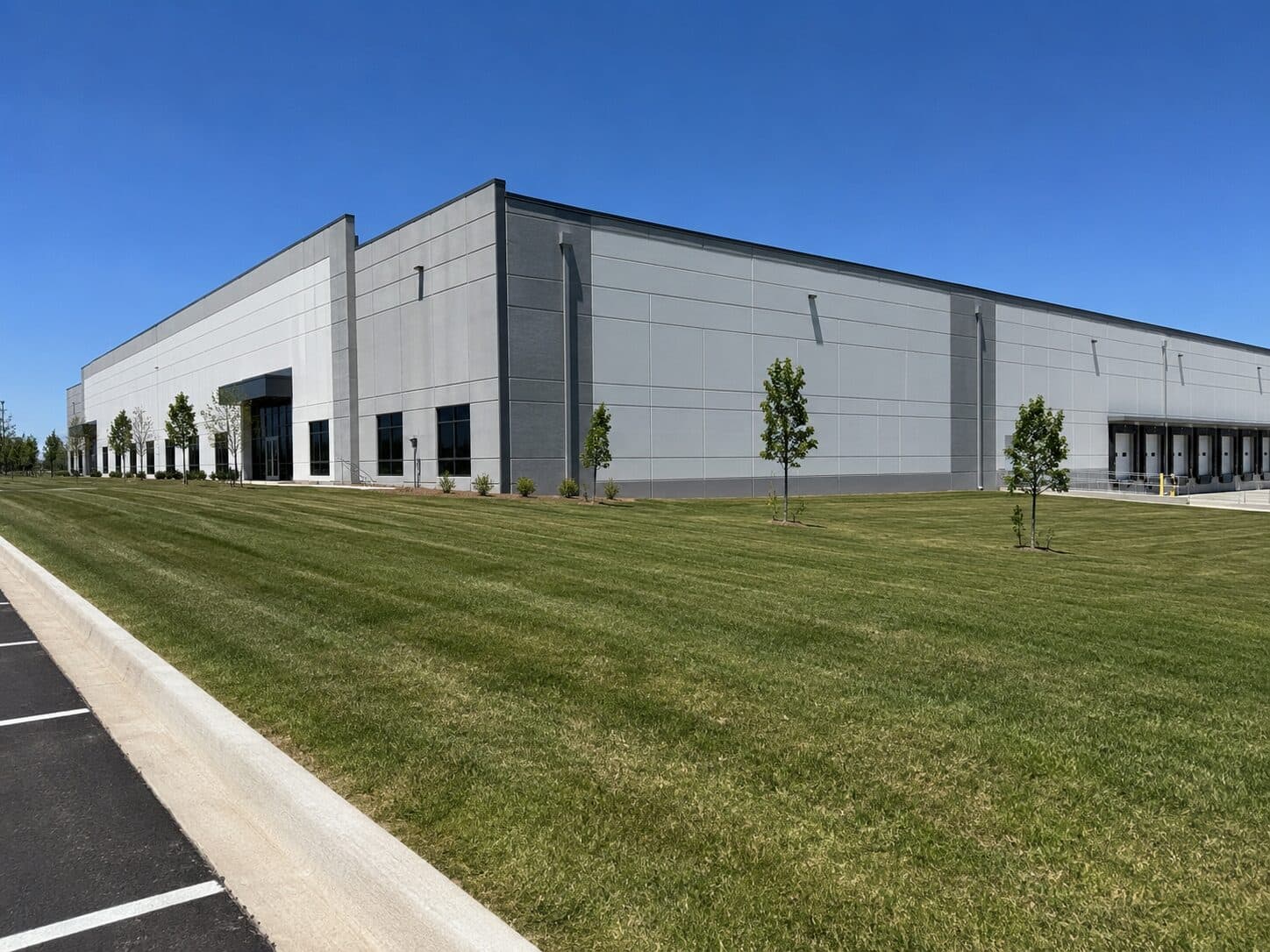 Industrial warehouse bordered by a landscaped lawn