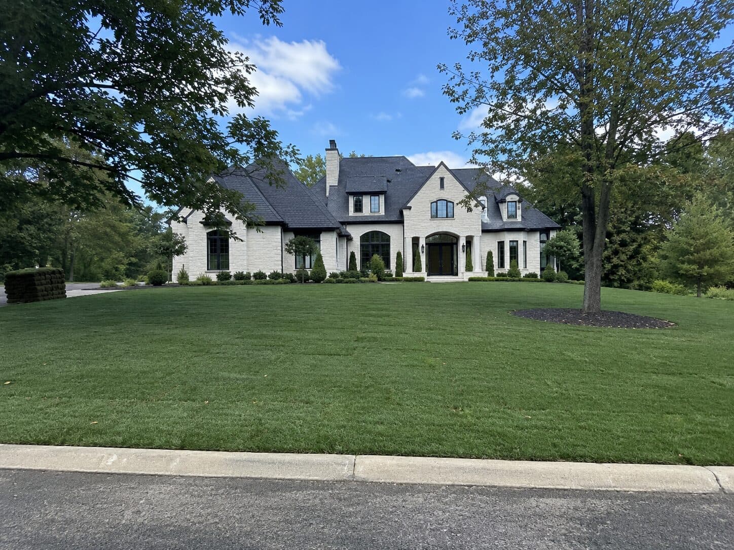 Elegant home framed by a carefully maintained green lawn