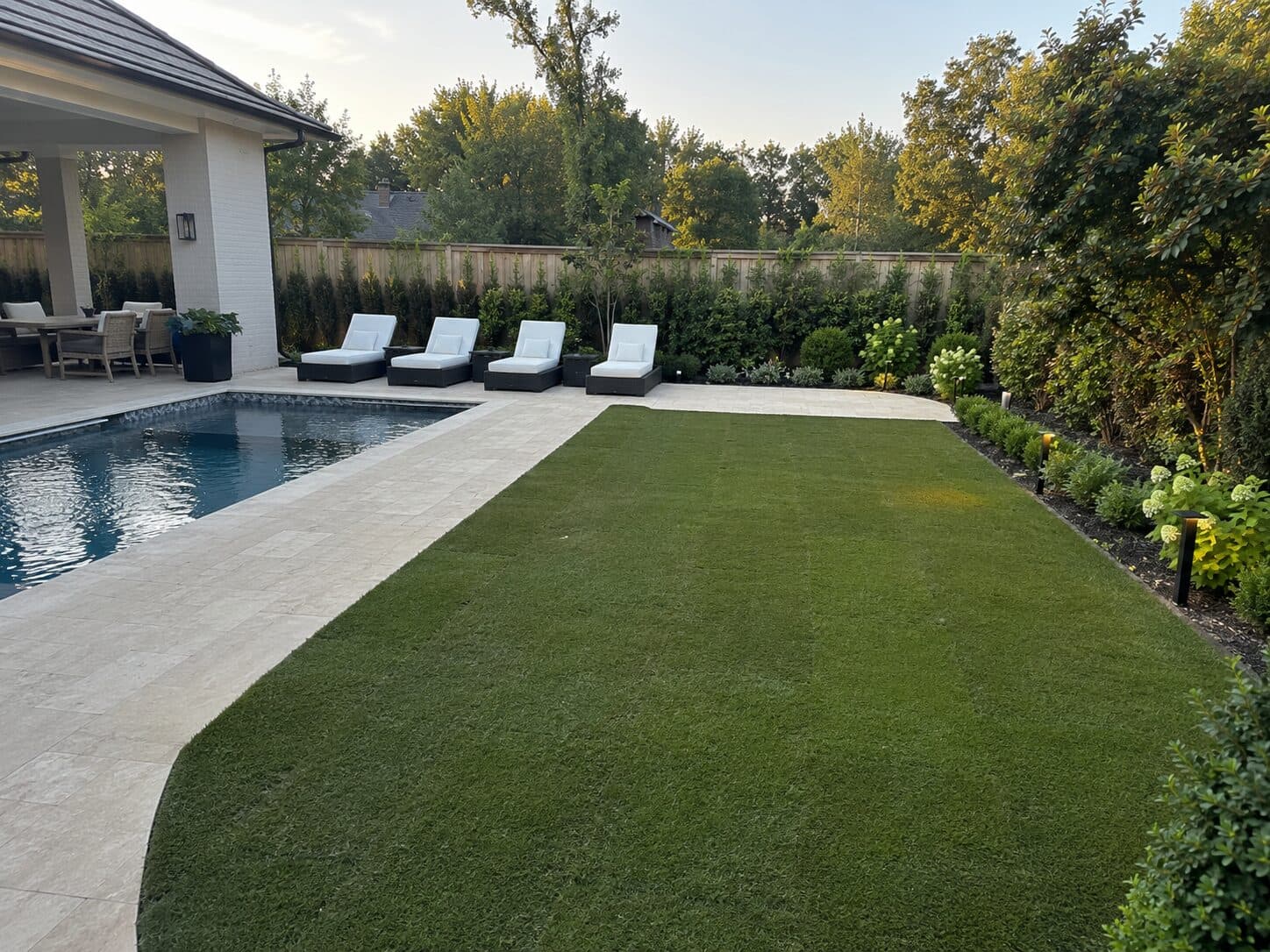 Modern backyard lawn and landscape at sunset