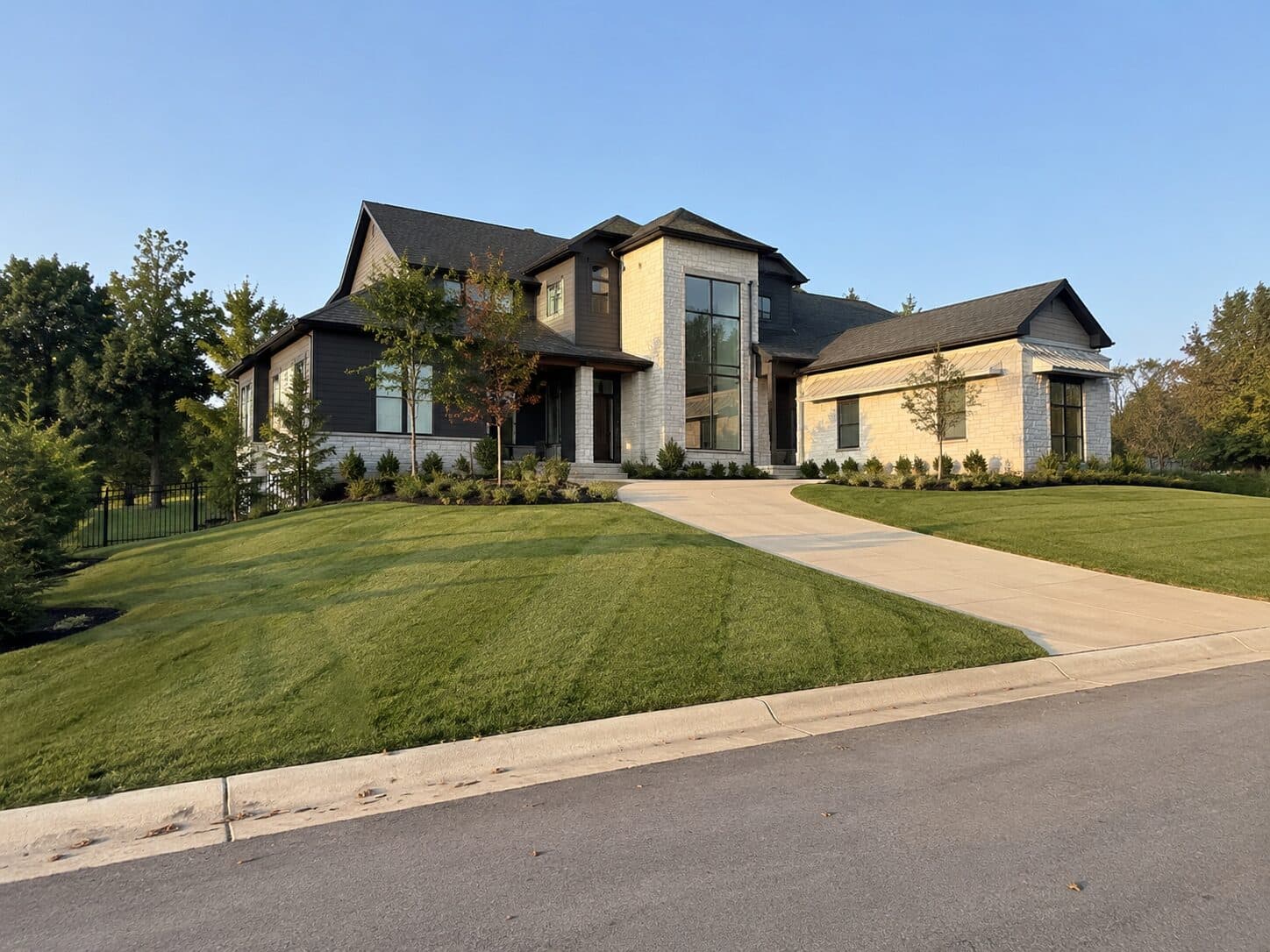 Modern home with a curved driveway and broad lawn