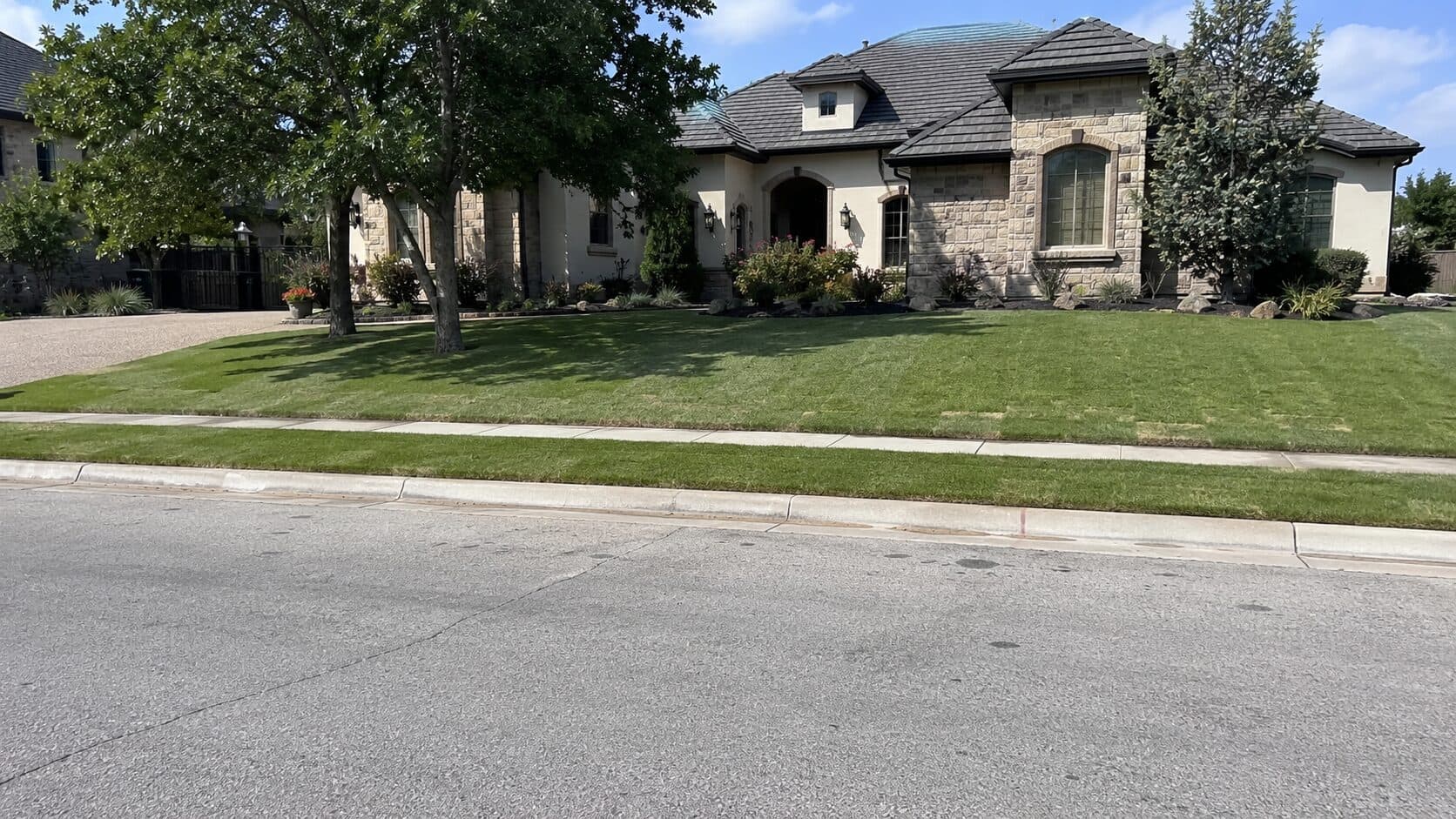 Suburban home with a lush front yard and green lawn